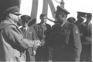 Chief of Staff Moshe Dayan and Major-General E. L. M. Burns end their meeting at the Lod airport to discuss further withdrawal of Israeli troops from Sinai 16 December 1956