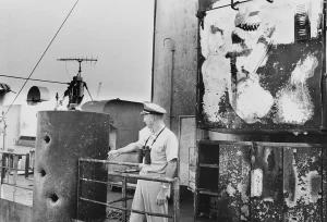 Commander William McGonagle inspects damage to USS Liberty after attack by Israeli forces