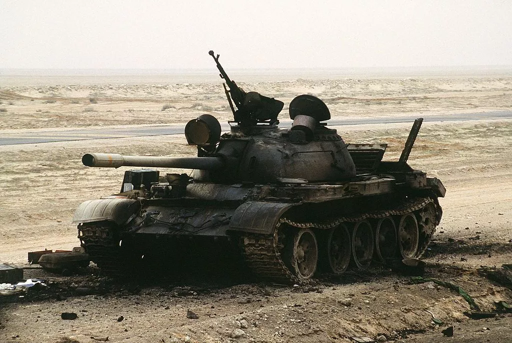 The charred remains of an Iraqi T-55 main battle tank sits on the Iraqi-Kuwait border, destroyed by Coalition armor heading into Kuwait during Operation Desert Storm