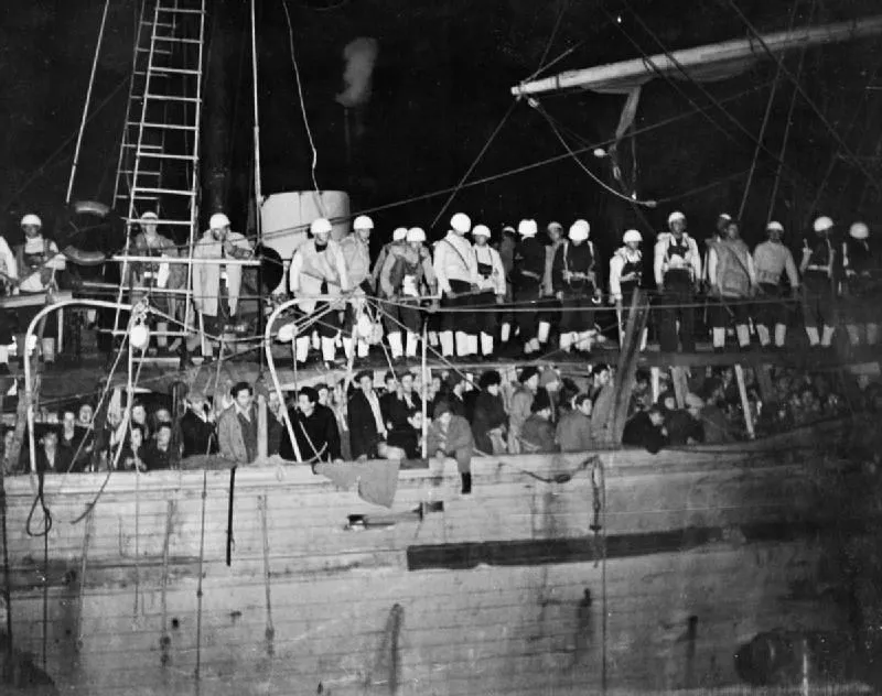 Illegal immigrants arriving into Palestine: The Jewish illegal immigrant ship Lanegev at the port of Haifa. A Royal Navy boarding party are seen on board the over-crowded vessel