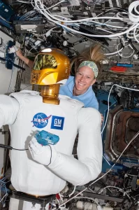 NASA astronaut Karen Nyberg, Expedition 36 flight engineer, is pictured with Robonaut 2, the first humanoid robot in space