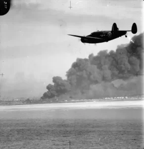 A Lockheed Hudson of No. 220 Squadron RAF approaches Dunkirk on a reconnaissance patrol during the evacuation of the British Expeditionary Force from the port in May-June 1940