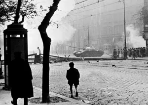 A Soviet tank attempts to clear a road barricade in Budapest, Hungary October 1956