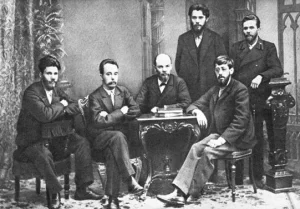 From left to right (standing) : P. K. Zaporozhets, A. A. Vaneyev. (sitting) : Victor V. Starkov, Gleb Krzhizhanovsky, Vladimir Lenin and Julius Martov. Saint Petersburg, 1897