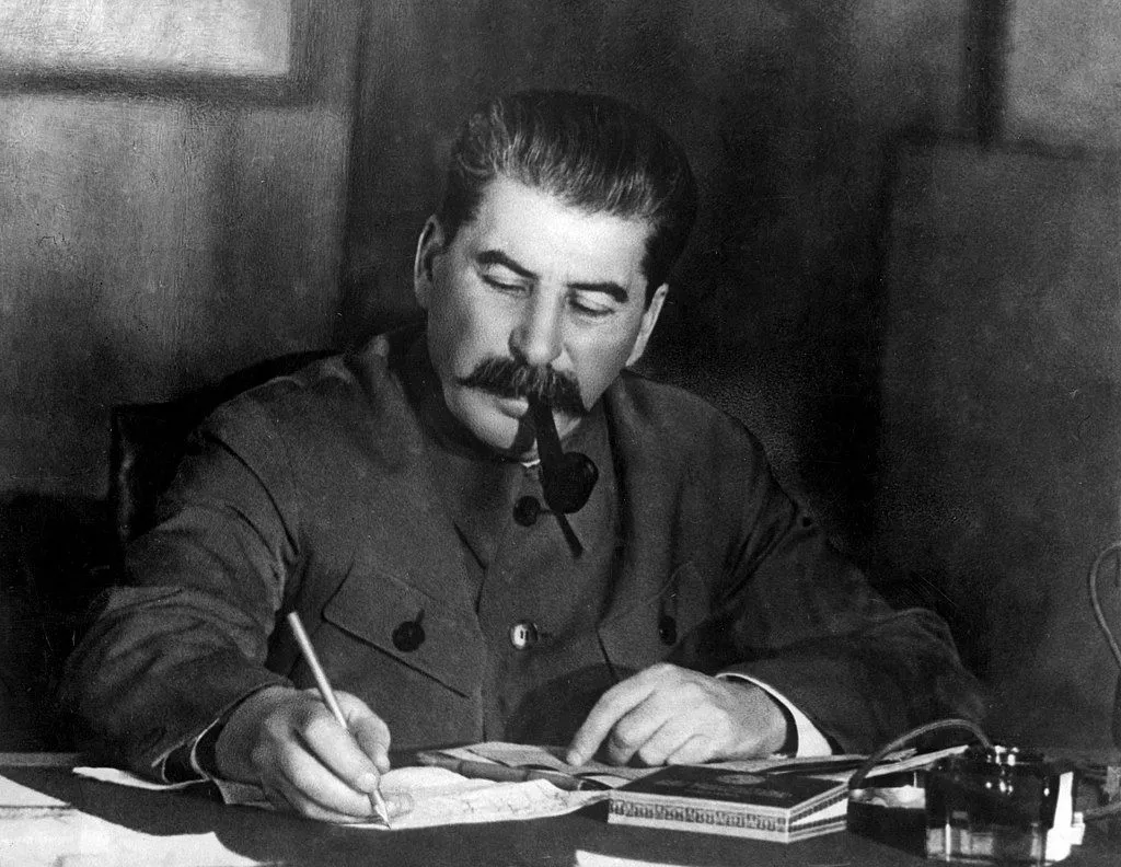 Before World War II. Joseph Stalin, with pipe in his mouth, writing at a desk. Stalin, general secretary of the Central Committee of the Communist Party of the Soviet Union at a conference in the Kremlin, Moscow, March 1935