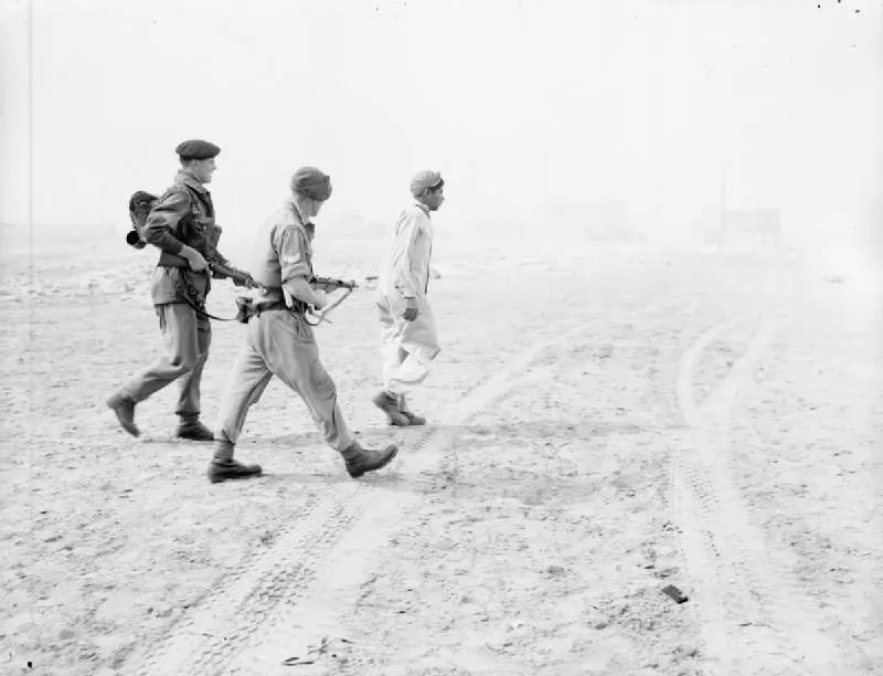 Troops of 3rd Battalion Parachute Regiment escort a captured Egyptian soldier on the beach at Port Said 5 November 1956