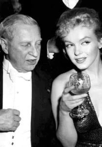 At left is the former US Ambassador to Great Britain, Winthrop W. Aldrich with Marilyn Monroe 12 April 1957