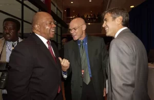 Congressman Elijah Cummings, Democratic Strategist James Carville and Actor/Producer George Clooney share a laugh after the Democratic Presidential