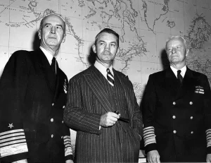 From left to right: Fleet Admiral Ernest J. King, Secretary of the Navy James Forrestal, and Fleet Admiral Chester W. Nimitz pose together at the Navy Department,