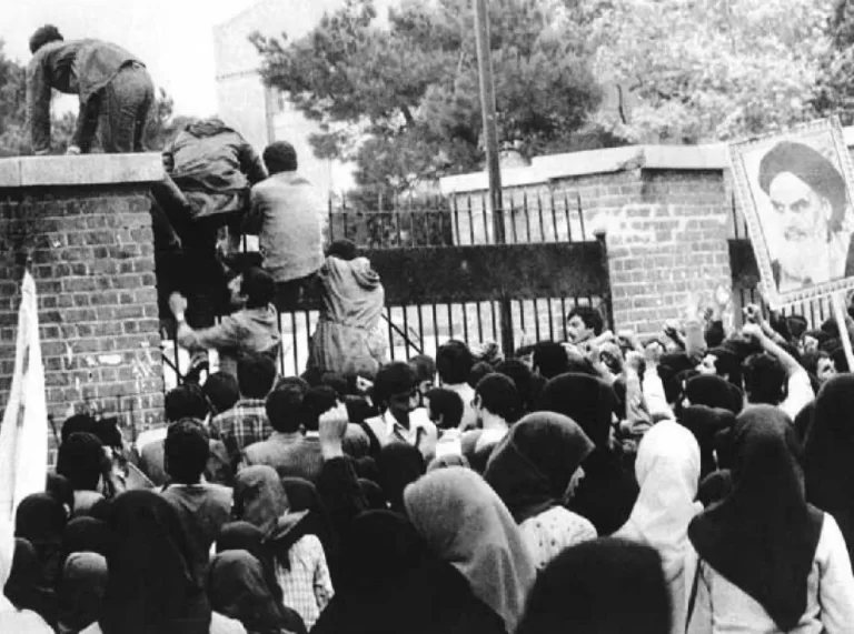 Iran hostage crisis - Iranian students climb up U.S. embassy gates in Tehran 4 November 1979