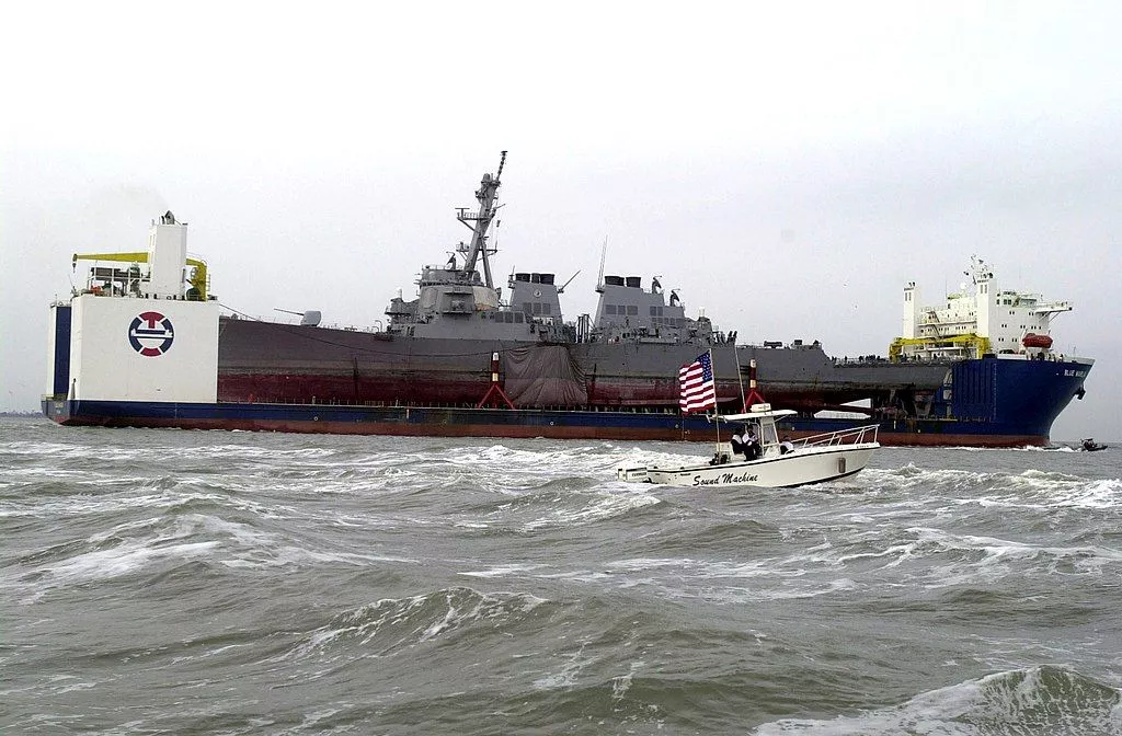 USS Cole (DDG 67) arrives at the Ingalls Shipyard in Pascagoula, Miss., aboard the Norwegian commercial lift ship MV Blue Marlin on Dec. 13, 2000