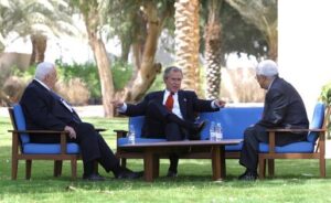 President George W. Bush of United States (center) discusses the Middle East peace process with Prime Minister Ariel Sharon of Israel (left) and Palestinian Prime Minister Mahmoud Abbas in Aqaba, Jordan, June 4, 2003