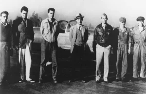 Flight test crew for the Jet Assisted Take-Off (JATO) experimental solid rocket booster. It was later refered to as RATO (Rocket Assisted Take-Off). From left to right are: F.S. Miller, J.W. Parsons, E.S. Foreman, Dr. Frank J. Malina, Capt. Homer A. Boushey Jr. Pvt. Kobe and Cpl. R. Hamilton.