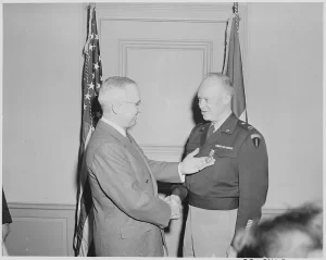 President Truman presents Gen. Dwight Eisenhower with the third Oak Leaf Cluster to the Distinguished Service Medal in a ceremony at the Pentagon.