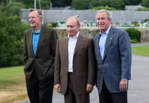 President George W. Bush stands with Russian President Vladimir Putin and Former President George H.W. Bush after Putin's arrival at Walker's Point in Kennebunkport, Maine, Sunday, July 1, 2007. White House photo by Eric Draper