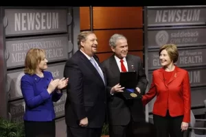 President George W. Bush, joined by Mrs. Laura Bush, is presented with the International Medal of PEACE by Pastor Rick Warren and his wife, Kay Warren, left, Monday, Dec. 1, 2008, following their participation at the Saddleback Civil Forum on Global Health in Washington, D.C.