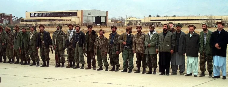 Northern Alliance troops line a runway at Bagram Air Base 16 December 2001