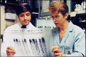 Dr. Jeffery Taubenberger and Dr. Ann Reid reviewing a genetic sequence from the 1918 Spanish flu virus.