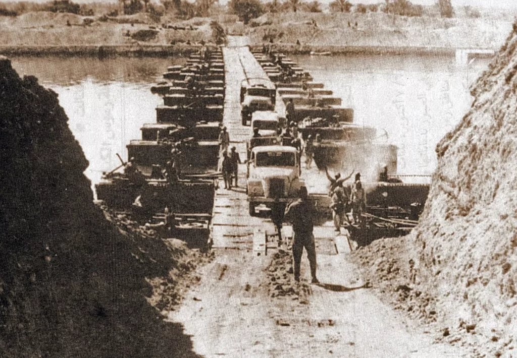 Egyptian military trucks cross a bridge laid over the Suez Canal on October 7, 1973, during the Yom Kippur War/October War