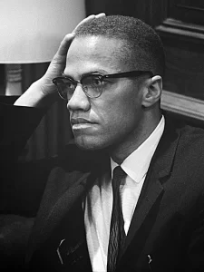 Malcolm X waiting for a press conference to begin on March 26, 1964