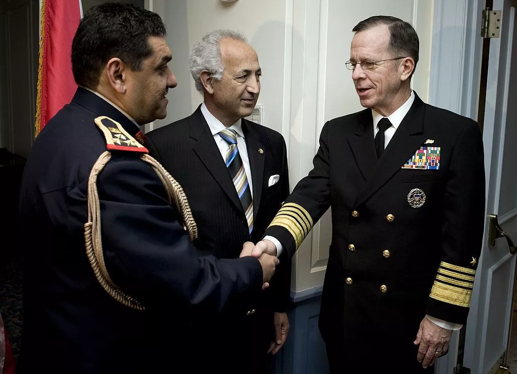 Mike Mullen, chairman of the Joint Chiefs of Staff, is greeted by Staff Brig. Gen. Ismael H. Alsodani, left, Iraqi Defense Attache, and Samir Al Sumaida'ie, Iraqi Ambassador to the U.S