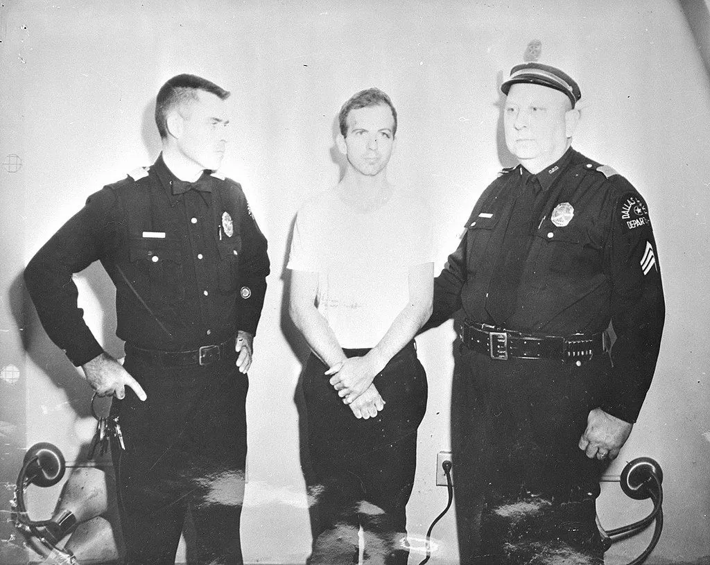 Lee Harvey Oswald and two policemen taken after Oswald's arrest