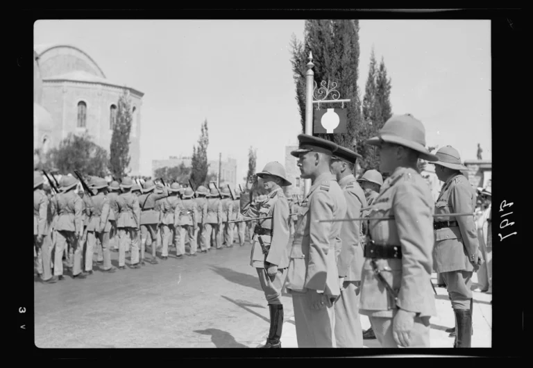 Palestine disturbances 1936. Lt. General Dill taking the salute as the Scots Guards parade passes down the Julian Way between the King David Hotel and the Y.M.C.A. building