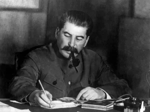 Before World War II. Joseph Stalin, with pipe in his mouth, writing at a desk. Stalin, general secretary of the Central Committee of the Communist Party of the Soviet Union at a conference in the Kremlin, Moscow, March 1935